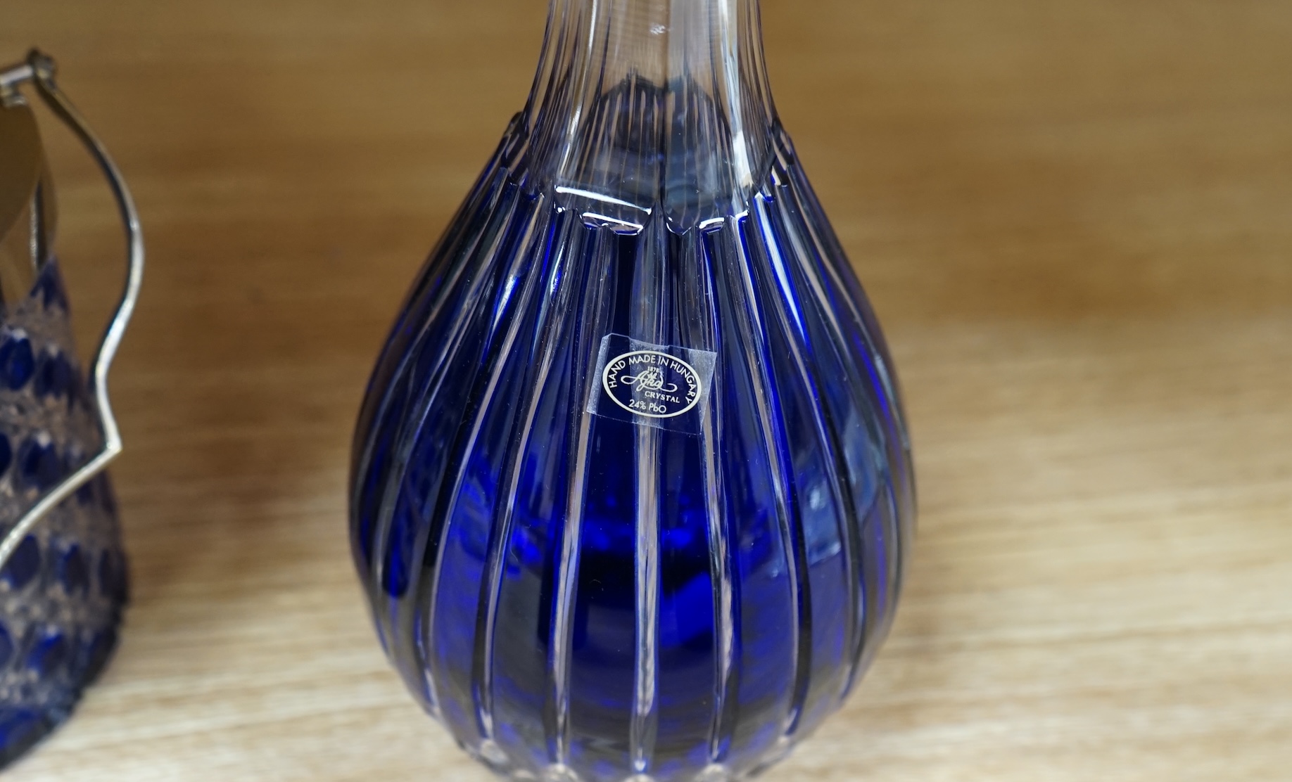 A collection of blue glassware comprising a late 18th century Bristol blue glass decanter and tear drop stopper, 30cm, a mid 19th century electroplate mounted blue glass decanter, a later Hungarian decanter and a similar